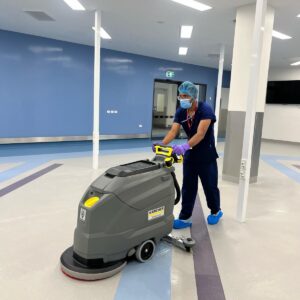 image of cleaner cleaning hospital floor with floor cleaner