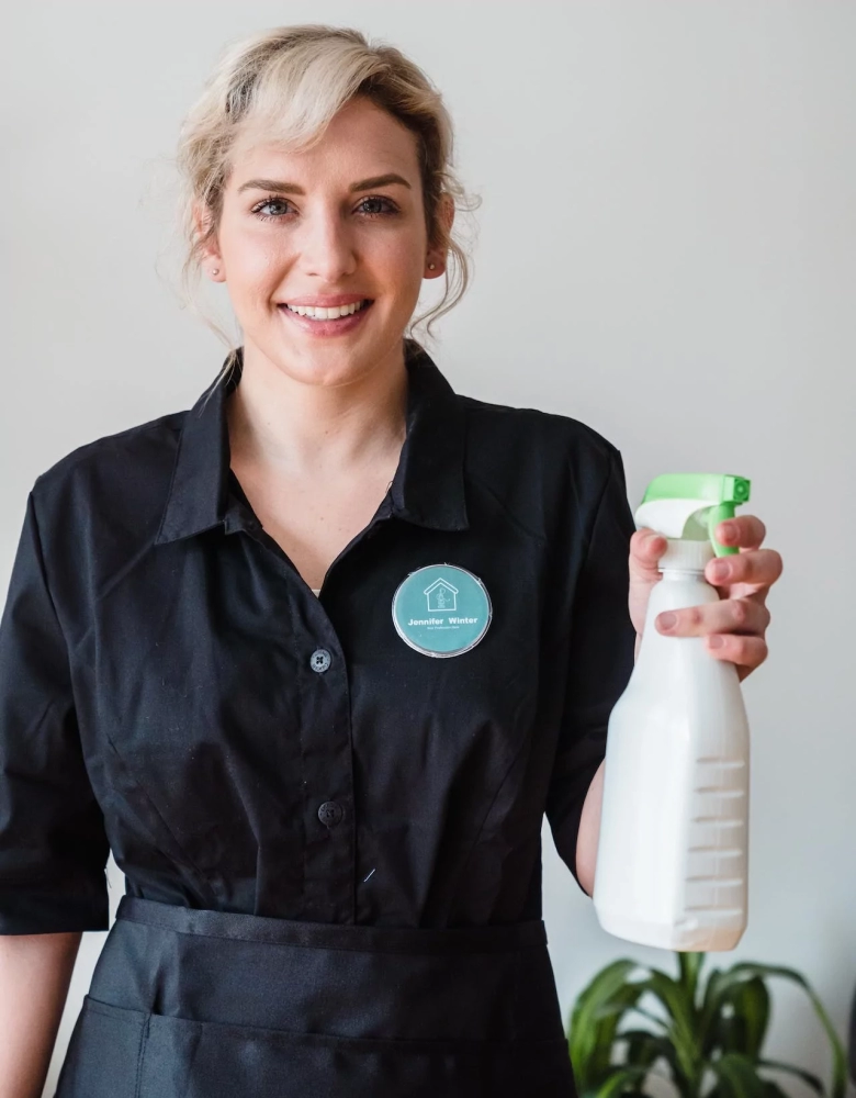 image of a smiling cleaning girl with a spray